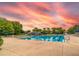 Large community pool with several swimming lanes, surrounded by plenty of seating and palm trees at 15944 Ternglade Dr, Lithia, FL 33547