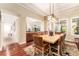 Elegant dining room features stylish light fixture, hardwood floors, and seating for eight at 15944 Ternglade Dr, Lithia, FL 33547