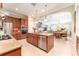 Gourmet kitchen boasts stainless appliances, center island, granite countertops, and custom cabinetry at 15944 Ternglade Dr, Lithia, FL 33547