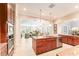 Open kitchen with stainless steel appliances, island, and views to the living room at 15944 Ternglade Dr, Lithia, FL 33547