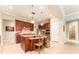 Stylish kitchen with stainless steel appliances, granite island, and breakfast bar seating at 15944 Ternglade Dr, Lithia, FL 33547