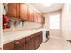Bright laundry room with upper cabinets and a modern washer and dryer at 15944 Ternglade Dr, Lithia, FL 33547