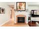 Cozy living room features a fireplace, stylish decor, and seamless flow to other rooms at 15944 Ternglade Dr, Lithia, FL 33547