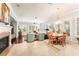 Bright open-concept living room featuring fireplace, tile floors, and hardwood dining area at 15944 Ternglade Dr, Lithia, FL 33547