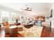 Bright living room features hardwood floors, a ceiling fan and an open concept layout at 15944 Ternglade Dr, Lithia, FL 33547