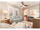 Bright and airy living room with a comfortable sofa, large windows, and modern decor at 15944 Ternglade Dr, Lithia, FL 33547