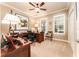 Well-lit home office with wood desk, neutral walls, and a ceiling fan at 15944 Ternglade Dr, Lithia, FL 33547