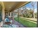 Comfortable screened patio with views of a lush lawn and mature trees for serene outdoor living at 15944 Ternglade Dr, Lithia, FL 33547