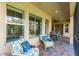 Charming screened patio with comfortable seating offering a tranquil view of the outdoors at 15944 Ternglade Dr, Lithia, FL 33547