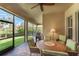 Inviting screened patio with cozy seating and dining areas, perfect for outdoor relaxation at 15944 Ternglade Dr, Lithia, FL 33547