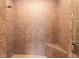 Tiled shower equipped with a bench, a showerhead and glass doors at 15944 Ternglade Dr, Lithia, FL 33547