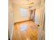 Clean bedroom featuring hardwood floors, a ceiling fan, closet, and window at 1609 Shady Oaks Dr, Oldsmar, FL 34677