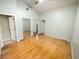 Spacious bedroom with hardwood floors, mirrored closet doors, and multiple entrances at 1609 Shady Oaks Dr, Oldsmar, FL 34677