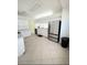 Bright kitchen with stainless steel refrigerator, white cabinets, plenty of counter space, and tiled flooring at 1609 Shady Oaks Dr, Oldsmar, FL 34677