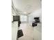 Well-lit kitchen features white cabinets, stainless steel appliances, and tiled flooring at 1609 Shady Oaks Dr, Oldsmar, FL 34677
