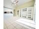Open living room featuring vaulted ceilings, a ceiling fan, a built-in shelving unit and sliding glass doors at 1609 Shady Oaks Dr, Oldsmar, FL 34677