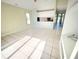 Spacious living room with vaulted ceilings, tile floors, and direct access to a modern kitchen at 1609 Shady Oaks Dr, Oldsmar, FL 34677