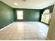 Spacious living room featuring tile flooring, two windows allowing for natural light, and neutral walls at 1609 Shady Oaks Dr, Oldsmar, FL 34677