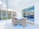 A covered patio offers a peaceful retreat with comfortable seating and views of the landscaped backyard at 1609 Shady Oaks Dr, Oldsmar, FL 34677