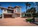 Stunning two-story waterfront home with brick driveway and landscaping at 181 And 199 21St Ave, St Pete Beach, FL 33706