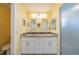 Bathroom featuring dual sinks with granite countertops, modern fixtures, and a glass-enclosed shower at 227 N Brockfield Dr, Sun City Center, FL 33573