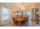 Elegant dining room with a chandelier, window, tile floors, and sliding glass doors to the pool at 227 N Brockfield Dr, Sun City Center, FL 33573