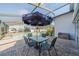 Outdoor pool area featuring a screened enclosure, brick paving, and an umbrella-covered patio table with chairs at 227 N Brockfield Dr, Sun City Center, FL 33573