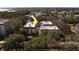 Aerial view of condo building with a red tile roof and surrounded by trees at 2612 Pearce Dr # 310, Clearwater, FL 33764