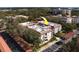 Aerial view of white condo complex surrounded by trees and surface parking at 2612 Pearce Dr # 310, Clearwater, FL 33764
