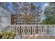 A peaceful balcony with seating overlooking lush greenery and the building's facade on a sunny day at 2612 Pearce Dr # 310, Clearwater, FL 33764