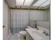 A full bathroom with tub, toilet, vanity with white sink and framed mirror at 2612 Pearce Dr # 310, Clearwater, FL 33764