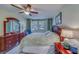 Cozy bedroom with a large window, ceiling fan, comfortable bed, dresser, and a serene atmosphere at 2612 Pearce Dr # 310, Clearwater, FL 33764
