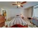 Bedroom with a ceiling fan, neutral carpet and bedding, and a closet for ample storage space at 2612 Pearce Dr # 310, Clearwater, FL 33764