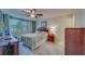 Bright bedroom features a large window, ceiling fan, writing desk, dresser and closet at 2612 Pearce Dr # 310, Clearwater, FL 33764