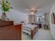 Comfortable bedroom featuring a ceiling fan, neutral carpet and bedding, and a convenient desk for work at 2612 Pearce Dr # 310, Clearwater, FL 33764