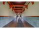 Arched hallway entrance with exposed wood beams and decorative tile flooring at 2612 Pearce Dr # 310, Clearwater, FL 33764