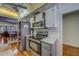 Kitchen featuring stainless steel appliances, white cabinets, gray countertops, and open view to the dining area at 2612 Pearce Dr # 310, Clearwater, FL 33764