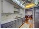 Kitchen showcasing marble countertops, tile backsplash, stainless steel appliances, and wood flooring at 2612 Pearce Dr # 310, Clearwater, FL 33764