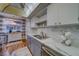 Bright kitchen featuring stainless appliances, white cabinets, gray counters, tile backsplash, and double basin sink at 2612 Pearce Dr # 310, Clearwater, FL 33764