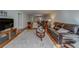 Inviting living room with hardwood floors, a comfortable sofa, and access to the dining area at 2612 Pearce Dr # 310, Clearwater, FL 33764