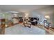 Spacious living room featuring wood floors, comfortable seating, a large area rug and a dining area in the background at 2612 Pearce Dr # 310, Clearwater, FL 33764