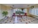 Sitting area in the lobby with table, chairs, neutral color palette, tiled floors, window, and a wall of mailboxes at 2612 Pearce Dr # 310, Clearwater, FL 33764