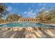 Beautiful community pool with surrounding lounge chairs is encased by a terracotta-roofed shelter at 2612 Pearce Dr # 310, Clearwater, FL 33764