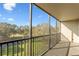 Screened balcony offering views of the community's manicured green space and blue sky at 2900 Cove Cay Dr # 4A, Clearwater, FL 33760