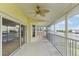 Enclosed porch showcasing beautiful water views, a ceiling fan, and access to the outdoor space at 3487 Amberjack Dr, Hernando Beach, FL 34607