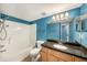 Bright bathroom with a granite vanity countertop, and a shower and tub combo at 3711 W Iowa Ave # 214, Tampa, FL 33611