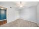 Carpeted bedroom with ceiling fan, closet, and doorway to an adjacent room at 3711 W Iowa Ave # 214, Tampa, FL 33611
