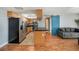 Well-designed kitchen with stainless steel appliances, wood cabinets, and a black countertop island at 3711 W Iowa Ave # 214, Tampa, FL 33611