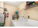 Well-equipped laundry room with washer, dryer, and storage shelving for convenience at 3711 W Iowa Ave # 214, Tampa, FL 33611