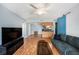 Spacious living room featuring wood floors, modern furnishings, and open access to other rooms in the house at 3711 W Iowa Ave # 214, Tampa, FL 33611